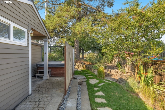 view of yard featuring a patio area and a hot tub