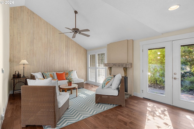 living room with ceiling fan, hardwood / wood-style flooring, lofted ceiling, and french doors