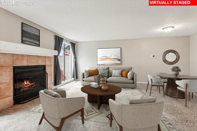 carpeted living room featuring a fireplace and a textured ceiling