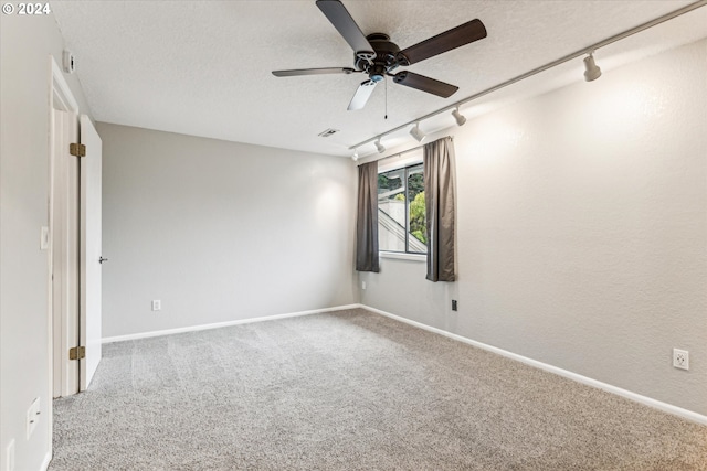 unfurnished room with carpet flooring, ceiling fan, a textured ceiling, and track lighting