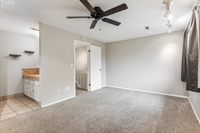 3320 NE 29th St, Gresham, OR 97030 - unfurnished bedroom featuring light colored carpet, a textured ceiling, track lighting, and a ceiling fan