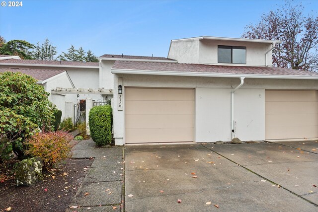 3320 NE 29th St, Gresham, OR 97030 - view of front of property with stucco siding, a garage, concrete driveway, and a shingled roof