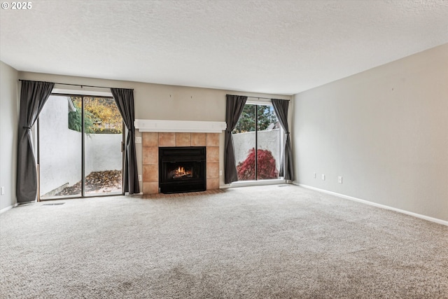 3320 NE 29th St, Gresham, OR 97030 - unfurnished living room with a tile fireplace, carpet floors, and a textured ceiling