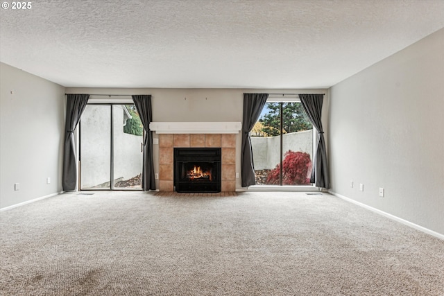 3320 NE 29th St, Gresham, OR 97030 - unfurnished living room featuring carpet floors, a tile fireplace, and a textured ceiling