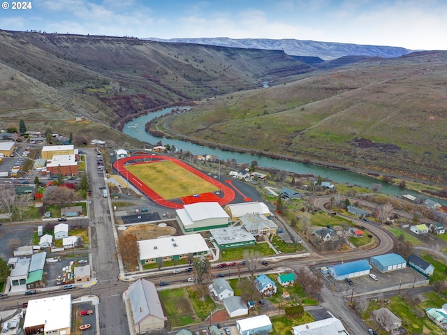 birds eye view of property featuring a water and mountain view