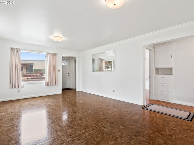 spare room featuring dark parquet flooring