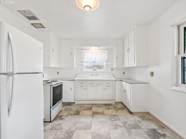 kitchen featuring white appliances, light tile floors, and white cabinets