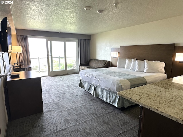 carpeted bedroom featuring a textured ceiling