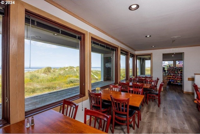 dining space with hardwood / wood-style floors and crown molding