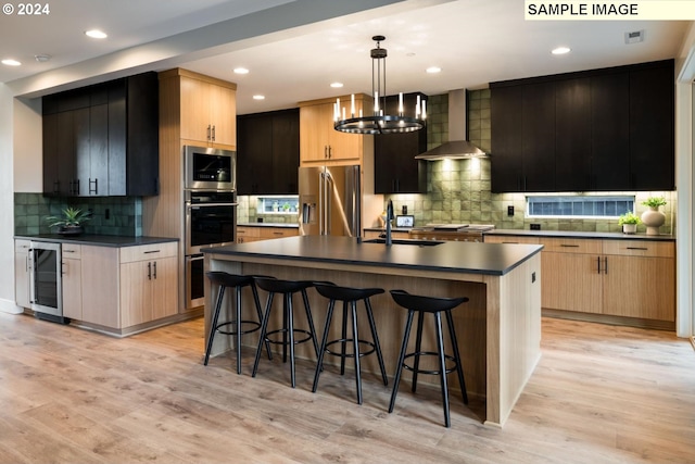 1108 N Helens View Dr, Ridgefield, WA 98642 - kitchen with beverage cooler, wall chimney exhaust hood, appliances with stainless steel finishes, dark countertops, and tasteful backsplash