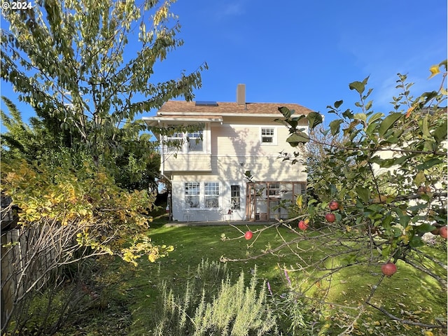 rear view of house with a lawn