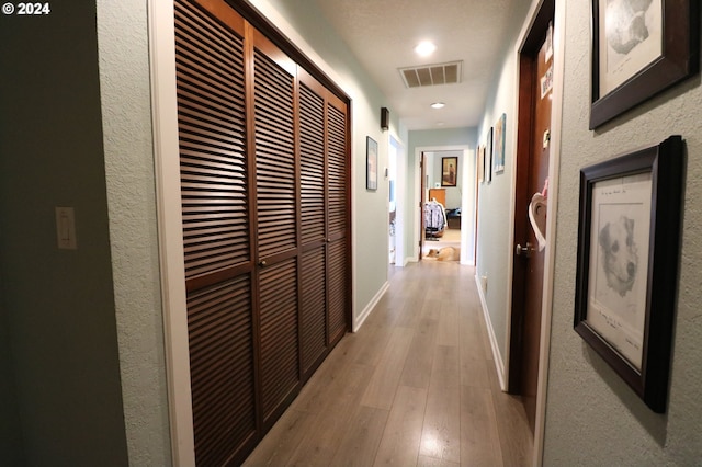 corridor featuring light hardwood / wood-style floors