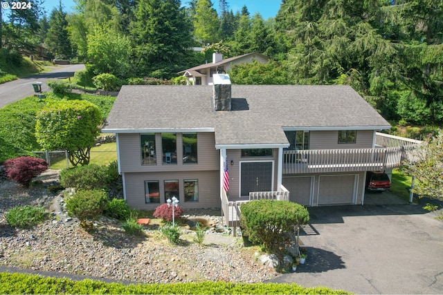 view of front of house with a garage and a wooden deck