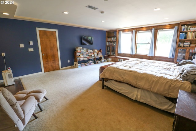 bedroom with carpet floors and ornamental molding