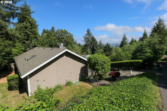 view of side of home featuring a yard