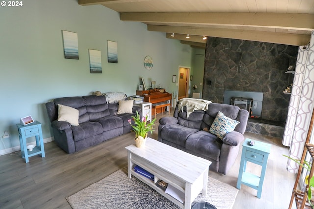 living room with vaulted ceiling with beams, hardwood / wood-style floors, and wooden ceiling