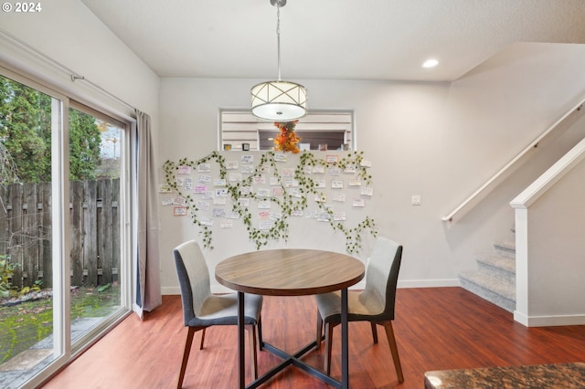 dining area with dark hardwood / wood-style flooring