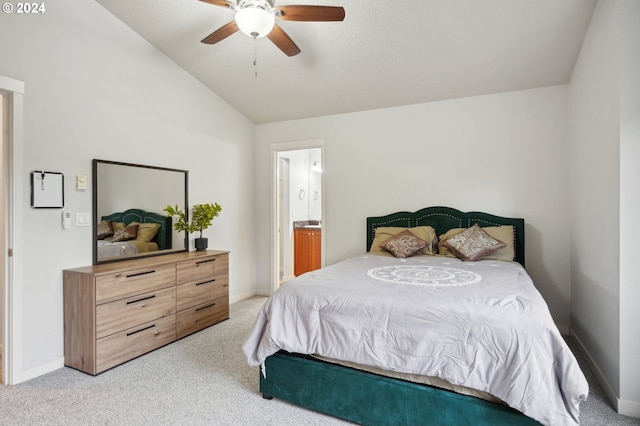 bedroom featuring light carpet, ensuite bathroom, ceiling fan, and lofted ceiling