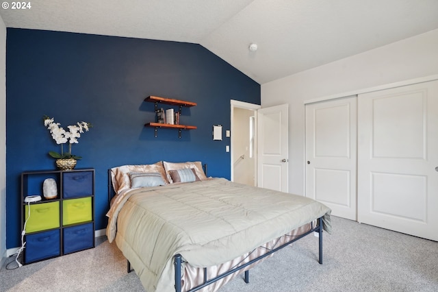 carpeted bedroom featuring a closet and lofted ceiling