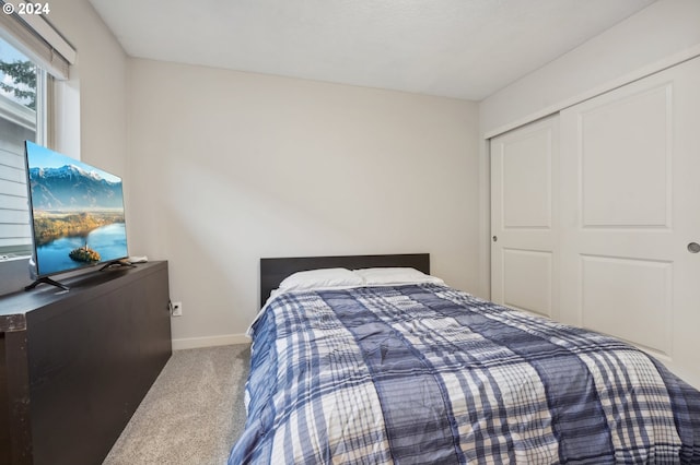 carpeted bedroom featuring a closet