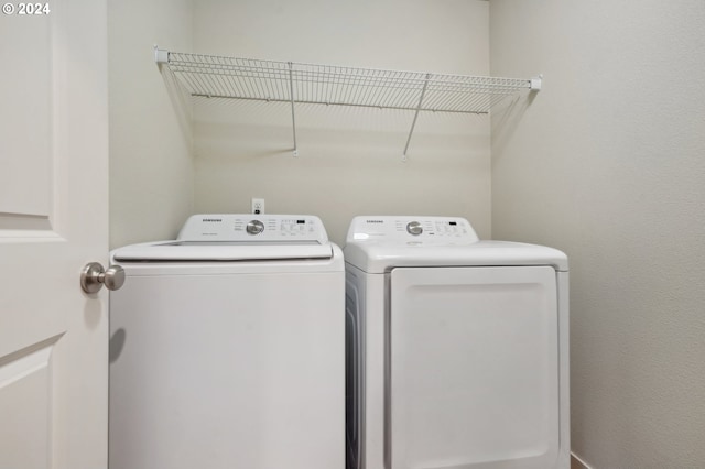 clothes washing area with washer and dryer