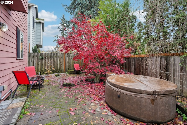 view of patio / terrace featuring a fire pit and a hot tub