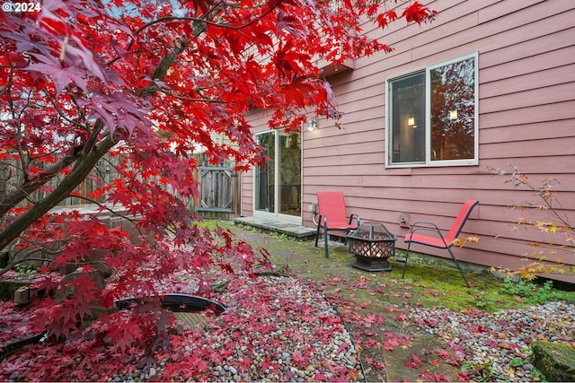 view of side of home with an outdoor fire pit