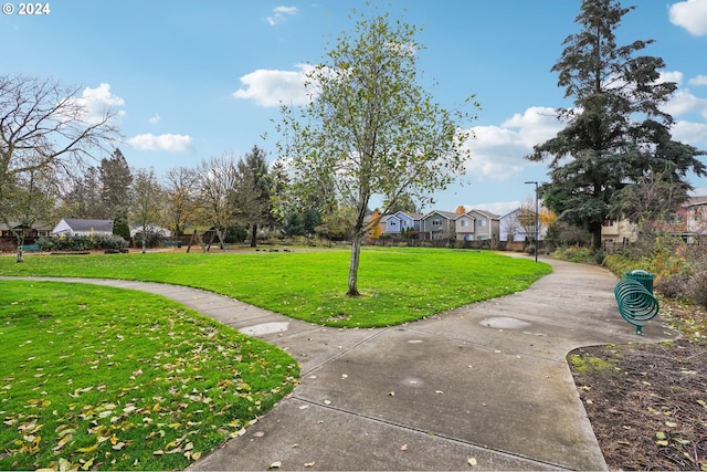 view of home's community with a yard