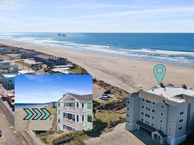 bird's eye view with a water view and a beach view