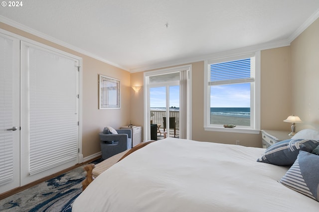 bedroom featuring access to outside, crown molding, and a water view