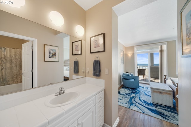 bathroom with vanity, wood-type flooring, and ornamental molding