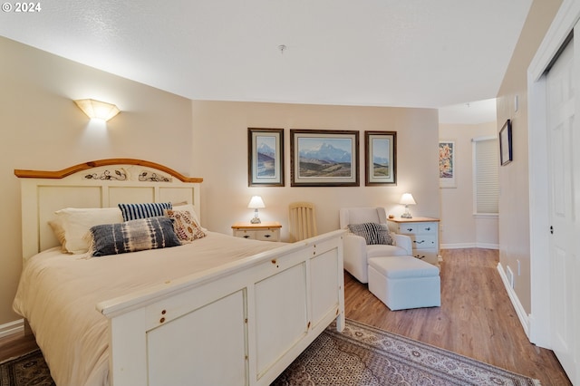 bedroom with light hardwood / wood-style floors