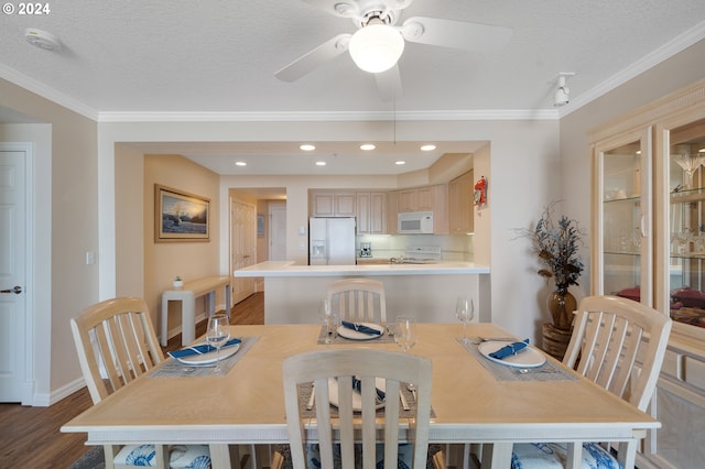 dining room with crown molding, ceiling fan, dark hardwood / wood-style flooring, and a textured ceiling