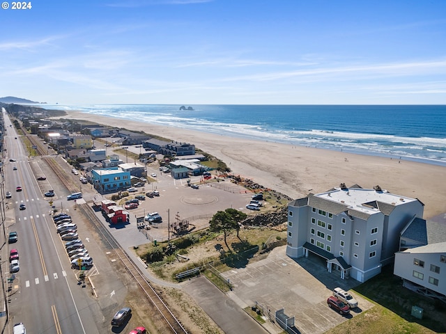 bird's eye view featuring a water view and a beach view