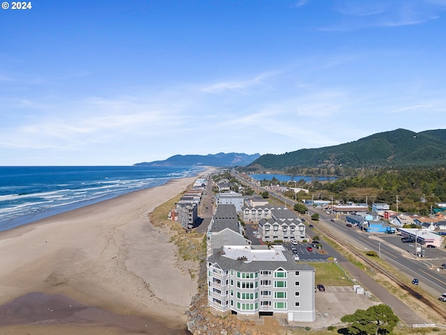 drone / aerial view featuring a beach view and a water and mountain view