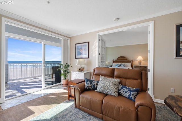 bedroom featuring a water view, light wood-type flooring, crown molding, and access to outside