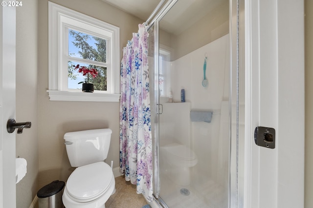 bathroom with tile patterned flooring, curtained shower, and toilet