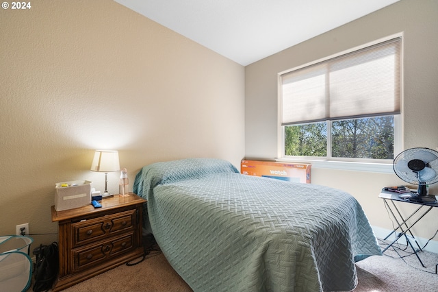 bedroom with lofted ceiling and carpet