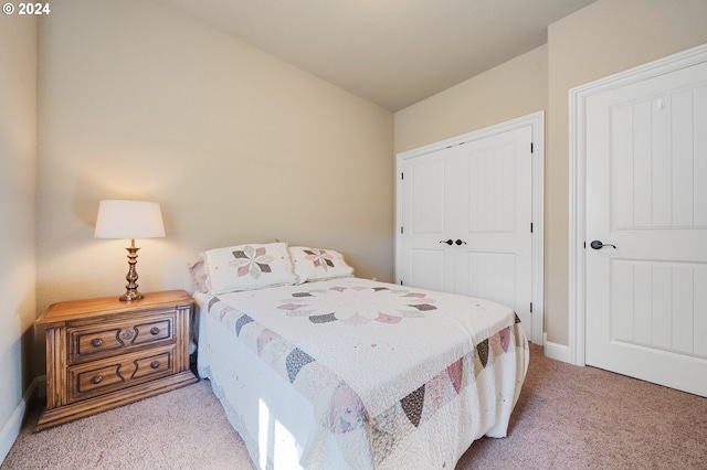 bedroom featuring light carpet and a closet