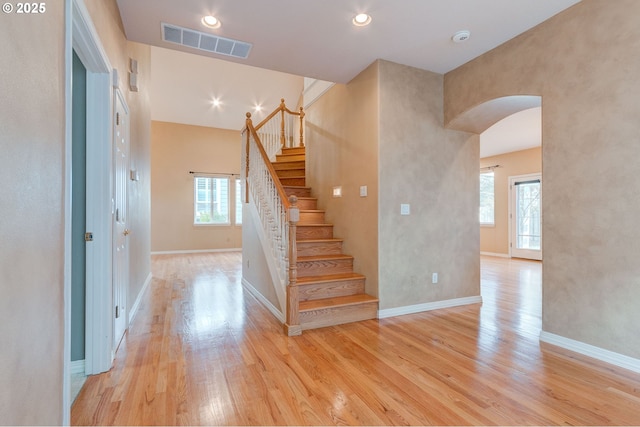 stairs featuring hardwood / wood-style floors