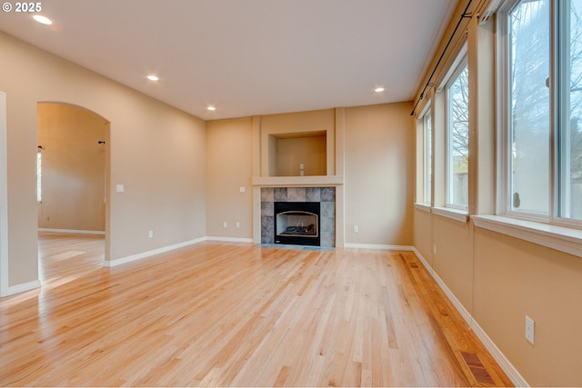 unfurnished living room with a fireplace and light wood-type flooring