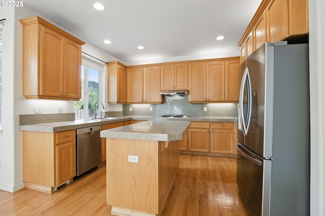 5306 NW Skycrest Pkwy, Portland, OR 97229 - kitchen featuring a center island, a sink, appliances with stainless steel finishes, light wood finished floors, and under cabinet range hood