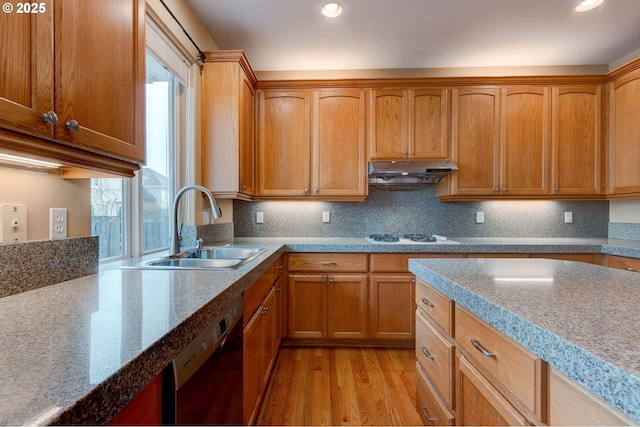 kitchen with white stovetop, tasteful backsplash, dishwasher, sink, and light hardwood / wood-style floors