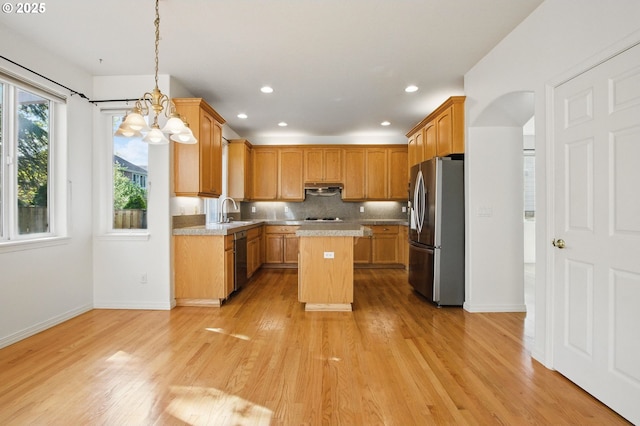5306 NW Skycrest Pkwy, Portland, OR 97229 - kitchen with a center island, baseboards, freestanding refrigerator, light wood-style floors, and dishwashing machine