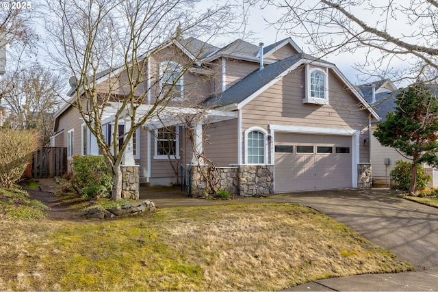 view of front of property with a garage and a front lawn