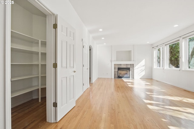 5306 NW Skycrest Pkwy, Portland, OR 97229 - unfurnished living room featuring baseboards, recessed lighting, wood finished floors, and a fireplace