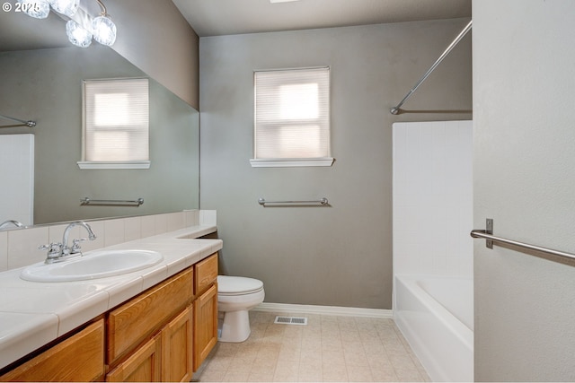 full bathroom featuring vanity, shower / bathing tub combination, a wealth of natural light, and toilet