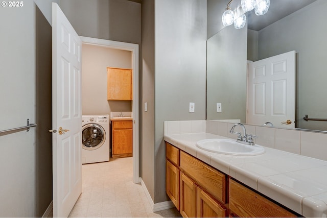 bathroom with vanity and washer / clothes dryer