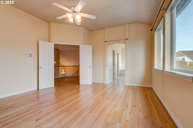 interior space with vaulted ceiling, ceiling fan, and light hardwood / wood-style flooring