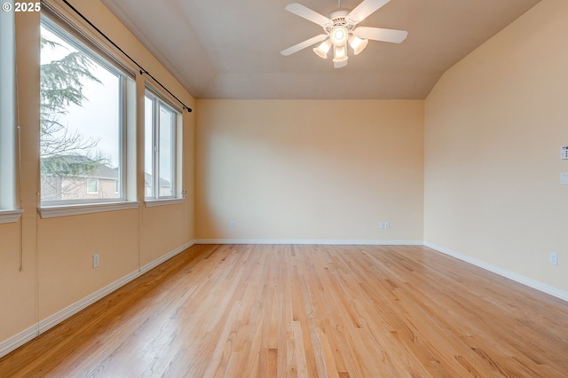 unfurnished room featuring ceiling fan, vaulted ceiling, and light wood-type flooring